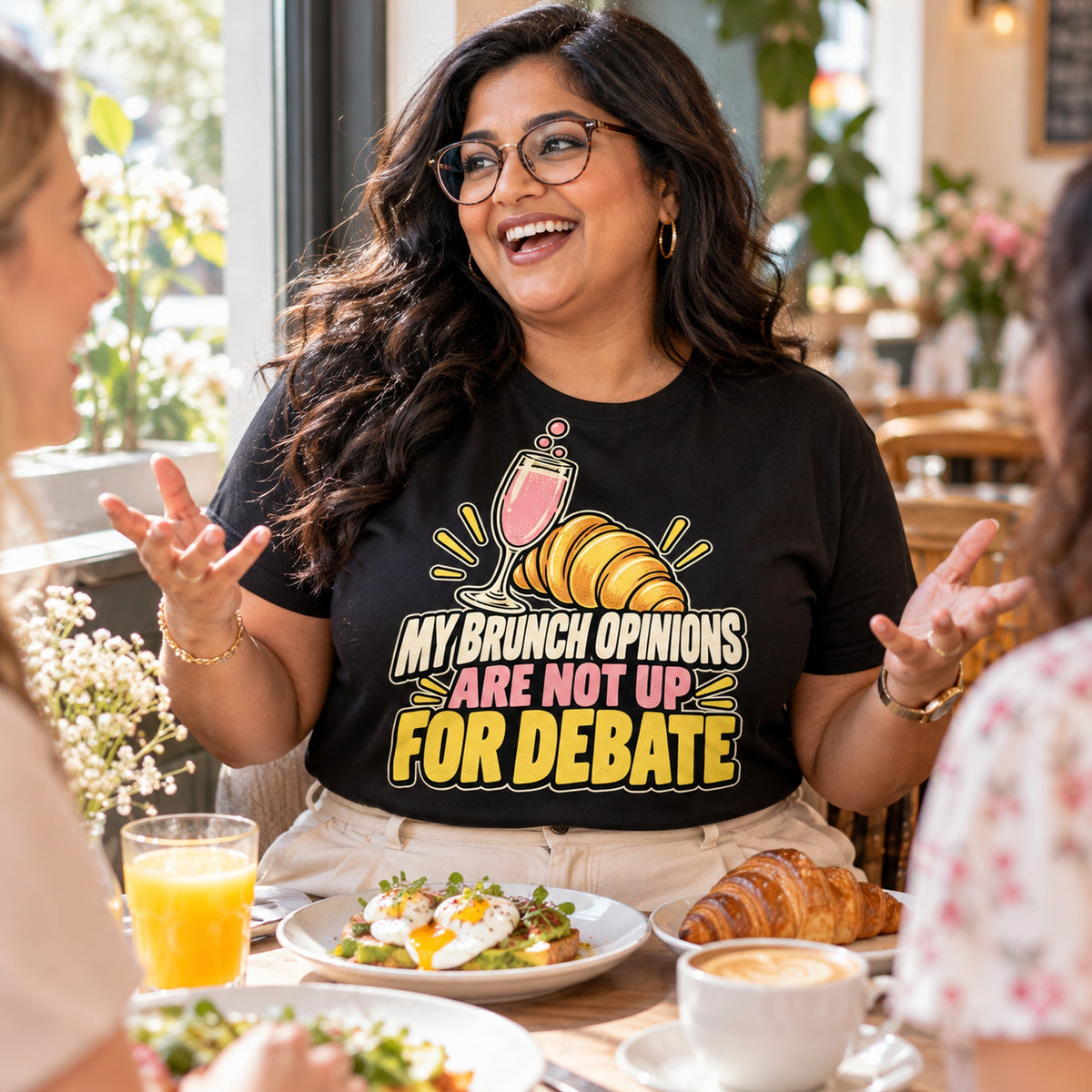 Woman wearing the Cute Croissant design black t-shirt at a brunch cafe