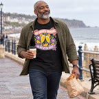 Man wearing the Floral Banner design black t-shirt on a seaside promenade