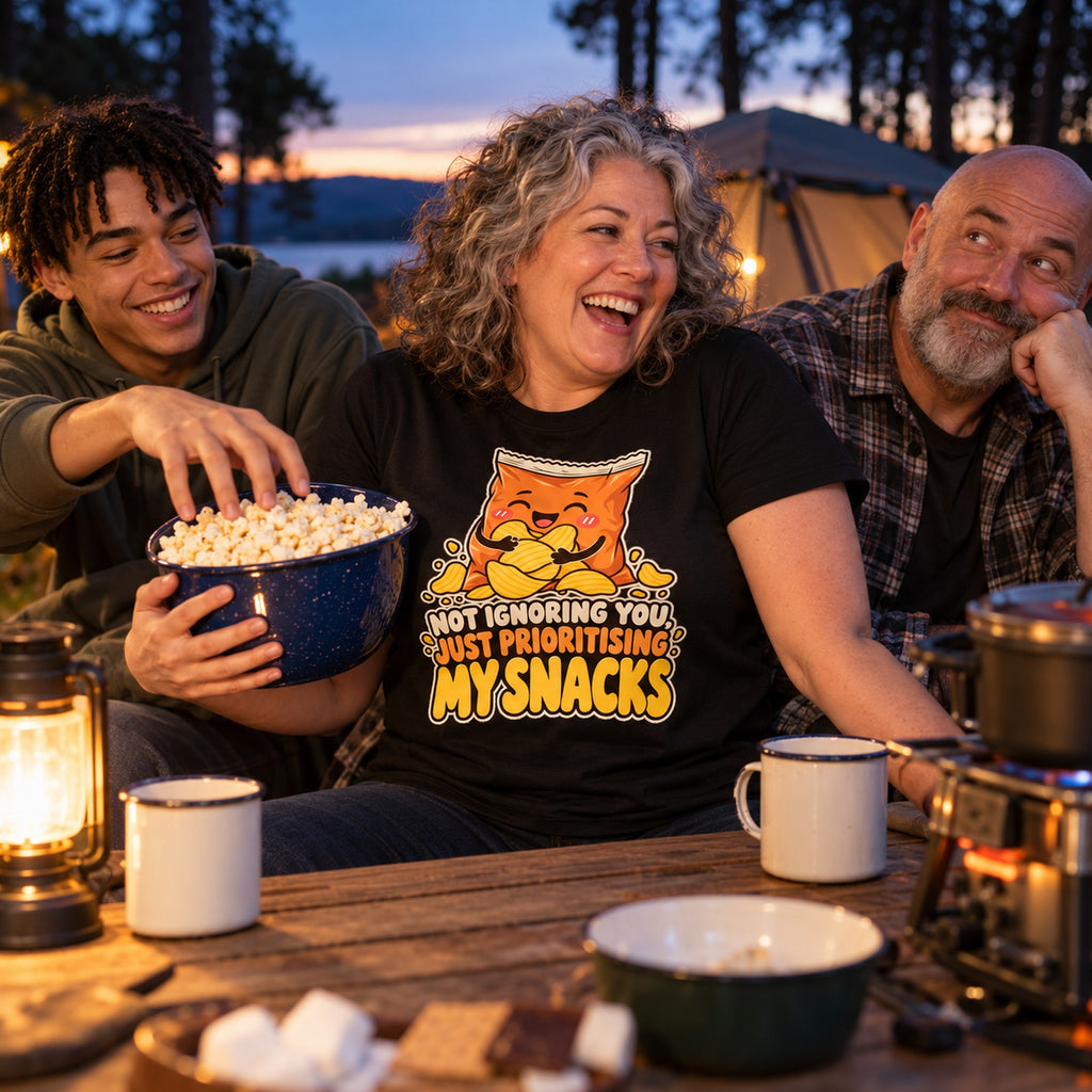 Family at a campsite table, mum wearing the Crisp Packet design black t-shirt