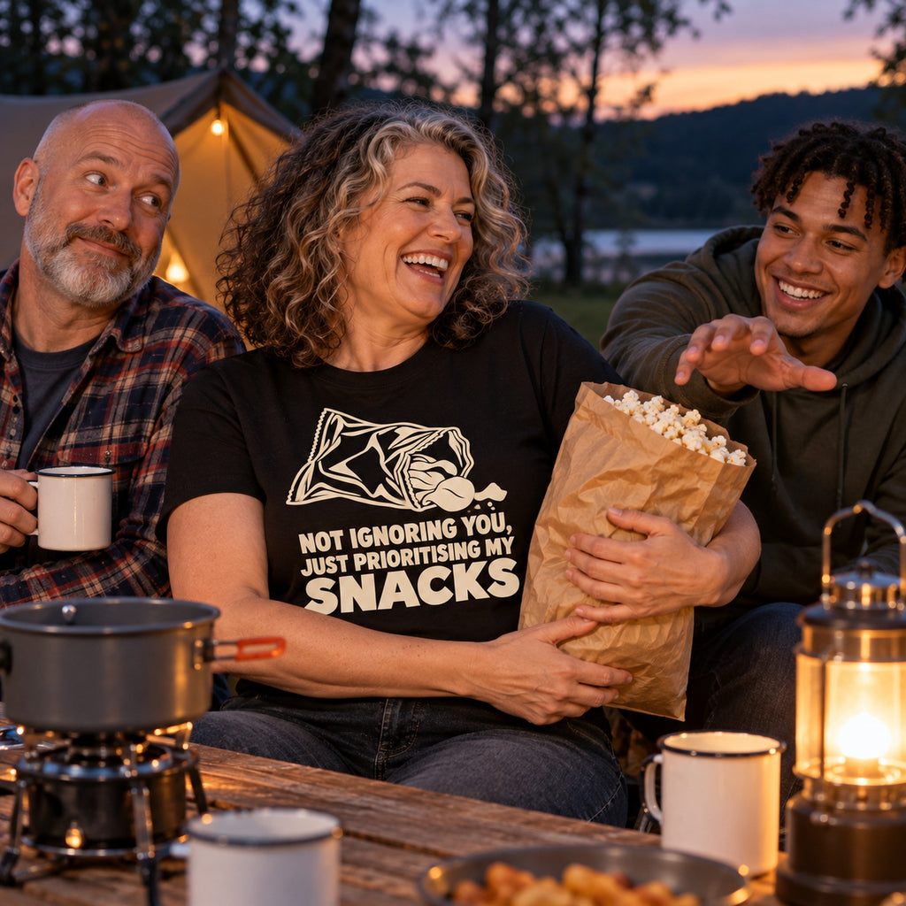 Family at a campsite table, mum wearing the Minimal Snack Bag design black t-shirt