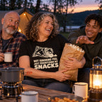 Family at a campsite table, mum wearing the Minimal Snack Bag design black t-shirt