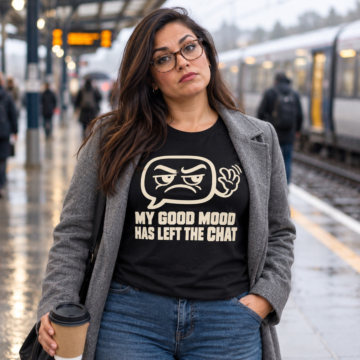 Woman wearing the Minimal Line design black t-shirt on a rainy railway platform