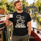 Man on a canal narrowboat wearing the Minimal Cup design black t-shirt, holding a mug of tea
