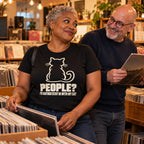 Couple in a vinyl record shop, woman wearing the Minimal Cat design black t-shirt