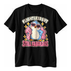Black t-shirt with a blue penguin in pink heart sunglasses and a pink feather boa above the text Flightless But Still Fabulous