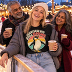 Family at an outdoor ice rink at a Christmas market, daughter wearing the Retro Penguin design black t-shirt