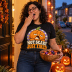 Woman wearing the Retro Pumpkin design black t-shirt on a front doorstep on Halloween evening holding a bowl of sweets