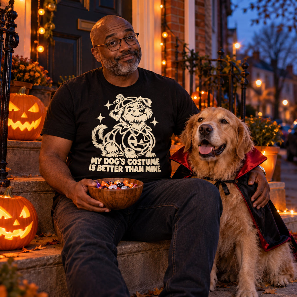 Man wearing the Line Pumpkin Dog design black t-shirt on a porch on Halloween evening with his golden retriever in a vampire cape