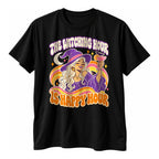 Black t-shirt with a smiling witch in a purple hat raising a pink cocktail on wavy rainbow stripes above the text The Witching Hour Is Happy Hour