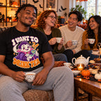 Friends wearing the Cute Vampire Cartoon design black t-shirt at a Halloween afternoon tea party with teapot and cakes