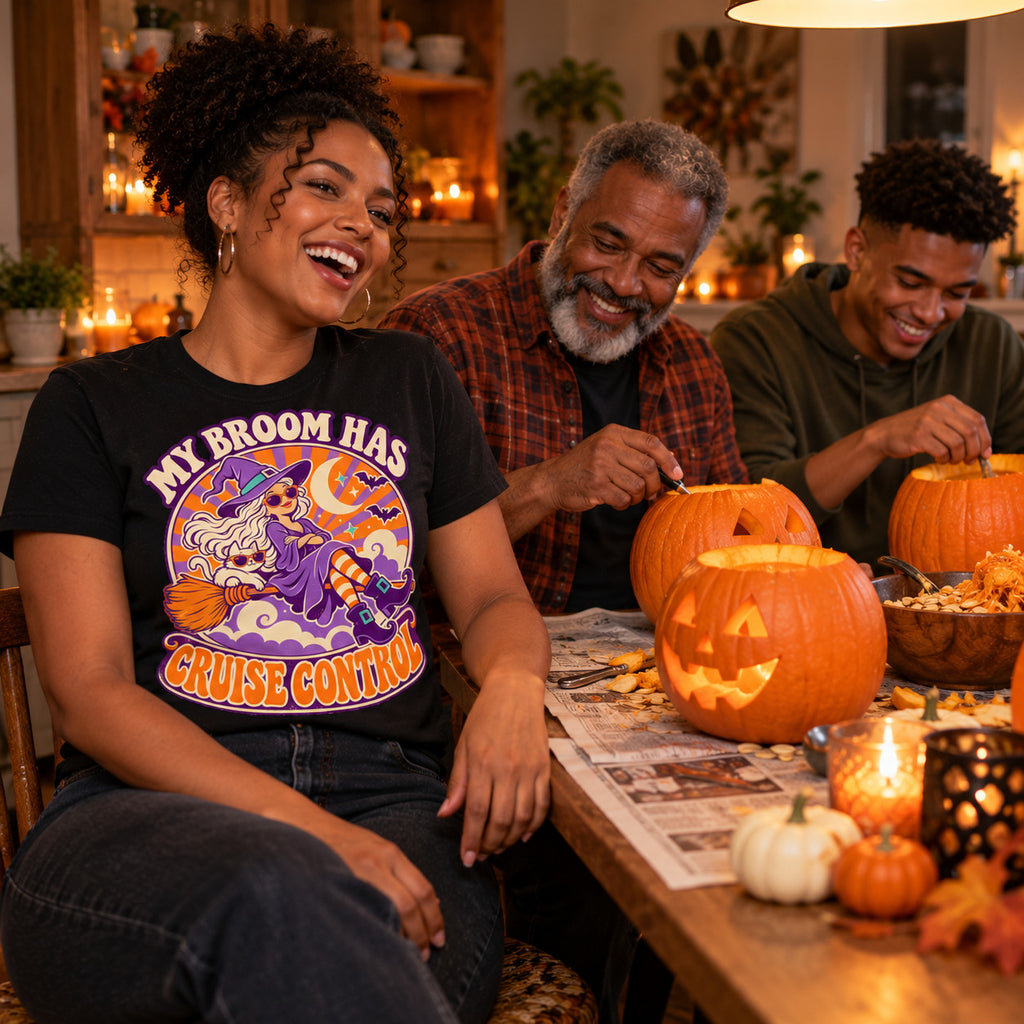 Family wearing the Retro Witch Badge design black t-shirt carving pumpkins at a kitchen table