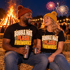 Couple wearing matching Bold Type Stack design black t-shirts on straw bales by a bonfire sharing a hot drink