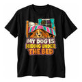 Black t-shirt with a cartoon dog peeking from under a bed with a striped blanket and the text My Dog Is Hiding Under The Bed