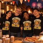 Four colleagues wearing matching Pixel Barrel design black t-shirts at a village hall fireworks fundraiser stall with a bonfire behind