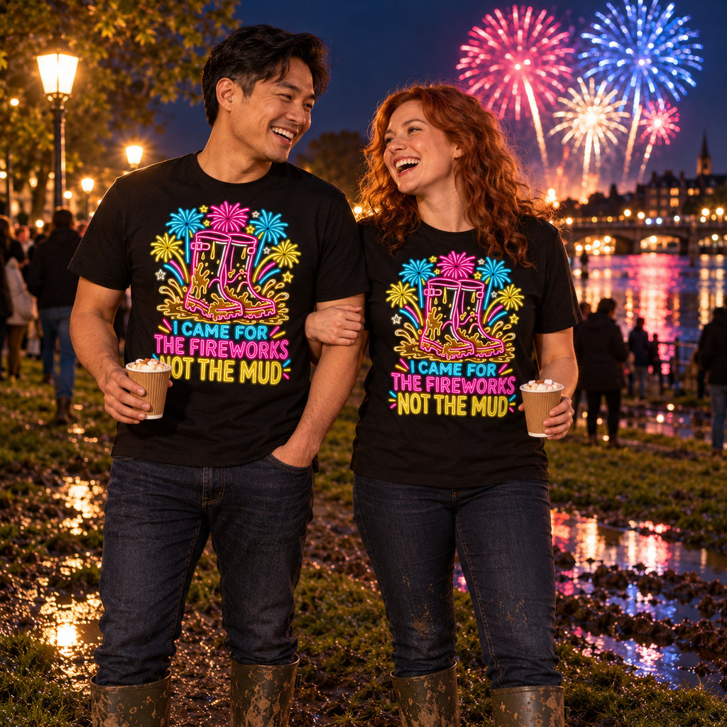 Couple wearing matching Neon Wellies design black t-shirts and wellington boots in a muddy riverside park at a fireworks night holding hot chocolates