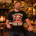 Man wearing the Woodcut Print design black t-shirt at the bar of a cosy British village pub at Christmas with an open fire