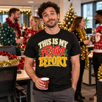 Man wearing the Bold Type design black t-shirt at a British office Christmas party with colleagues in Christmas jumpers behind