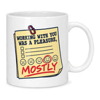 White mug with a yellow feedback form, circled smiley face and red pen writing reading Working With You Was A Pleasure, Mostly