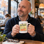 White mug with a yellow feedback form, circled smiley face and red pen writing reading Working With You Was A Pleasure, Mostly, lifestyle photo 1