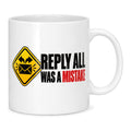 White mug with a yellow warning sign, black envelope and bold black and red text reading Reply All Was A Mistake