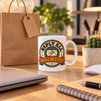 White mug with a round retro badge, lightning envelope and rust ribbon reading Reply All Was A Mistake, lifestyle photo 2