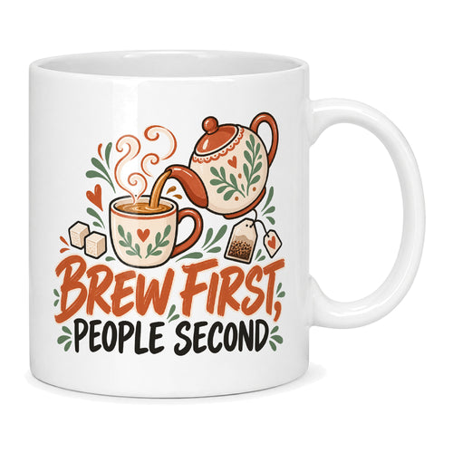 White mug with a teapot, cup, sugar cubes and terracotta and charcoal lettering reading Brew First, People Second
