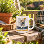 White mug with an open door, a puzzled cartoon man in pyjamas, a mustard question mark and navy lettering reading I Came In Here For Something. No Idea What., lifestyle photo 2