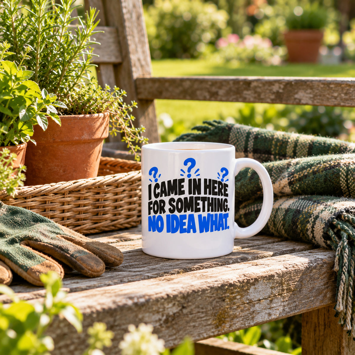 White mug with huge stacked black letters, blue question marks and blue last line reading I Came In Here For Something. No Idea What., lifestyle photo 2