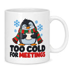 White mug with a grumpy cartoon penguin in a red and green scarf, blue snowflakes and black lettering reading Too Cold For Meetings with a red last word.